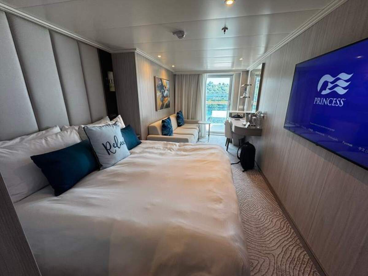  The perfect home at sea, our deluxe balcony stateroom on Star Princess with queen bed, seating area, and ocean-view sliding glass doors. Photo credit: Emily Molina 