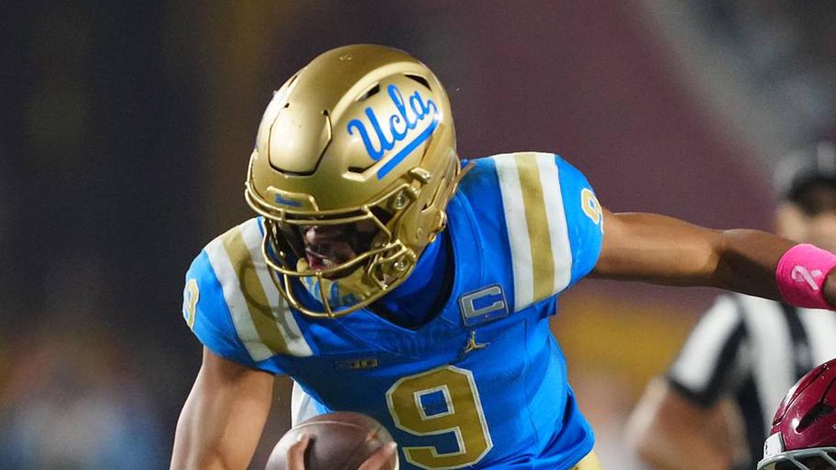  Nov 29, 2025; Los Angeles, California, USA; UCLA Bruins quarterback Nico Iamaleava (9) is tackled by Southern California Trojans linebacker Eric Gentry (18) in the second half at United Airlines Field at Los Angeles Memorial Coliseum. Mandatory Credit: Kirby Lee-Imagn Images | Kirby Lee-Imagn Images 