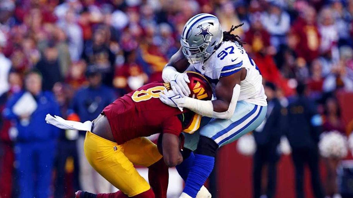  Nov 24, 2024; Landover, Maryland, USA; Washington Commanders running back Brian Robinson Jr. (8) is tackled by Dallas Cowboys defensive tackle Osa Odighizuwa (97) during the second quarter at Northwest Stadium. Mandatory Credit: Peter Casey-Imagn Images | Peter Casey-Imagn Images 