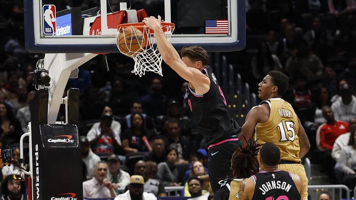  Apr 10, 2026; Washington, District of Columbia, USA; Miami Heat guard Pelle Larsson (9) dunks the ball and Washington Wizards forward Julian Reese (15) defends in the second half at Capital One Arena. Mandatory Credit: Geoff Burke-Imagn Images | Geoff Burke-Imagn Images 