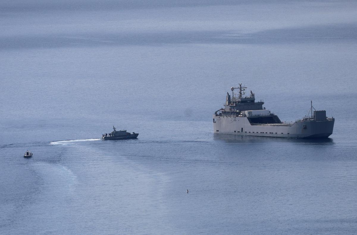 Greek Coast Guard vessels approach an Israeli vessel carrying activists of the Global Sumud Flotilla, which was intercepted on international waters by the Israeli Navy, off the port of Atherinolakkos, on the island of Crete, Greece, May 1, 2026. REUTERS/Stefanos Rapanis