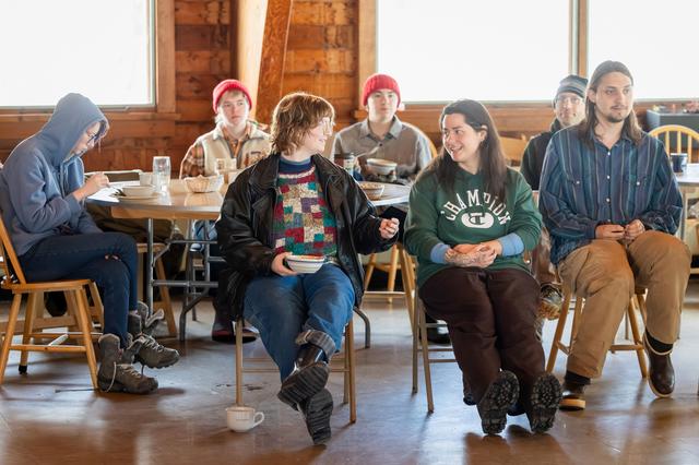  Students gather for a community meeting after lunch in the dining hall at Sterling College in Craftsbury Common, Vermont. Among other things, they were reminded to share their contact information so they can keep in touch after the college closes forever at the end of this semester. Credit: Oliver Parini for The Hechinger Report