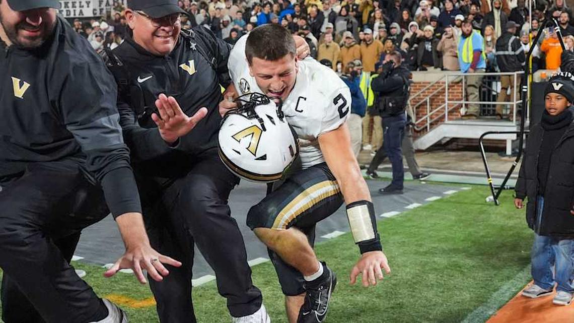  Vanderbilt quarterback Diego Pavia (2) poses as the Heisman trophy after winning a NCAA football game between Tennessee and Vanderbilt at Neyland Stadium in Knoxville, Tenn., on Nov. 29, 2025. | Angelina Alcantar/News Sentinel / USA TODAY NETWORK via Imagn Images 