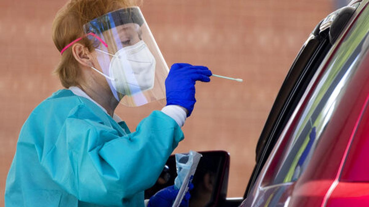 At this mobile testing site, medical personnel test people in vehicles for COVID-19, at Annandale High School, in Annandale, Va.