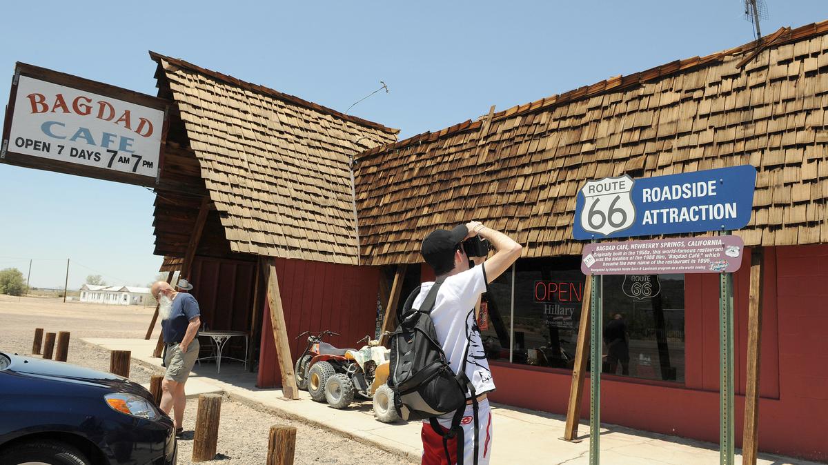 A French tourist takes pictures of the Bagdad Cafe on May 29, 2008 in the Mojave Desert on Route 66, in Newberry Springs, California. The establishment used in the movie "Bagdad Cafe", about 40(63 km) miles west of the original Bagdad site on historic Route 66 outside the town of Newberry Springs, was originally named the Sidewinder Cafe, but after its use as a filming location was later changed to the Bagdad Cafe. (Gabriel Bouys/AFP/Getty Images/TNS)
