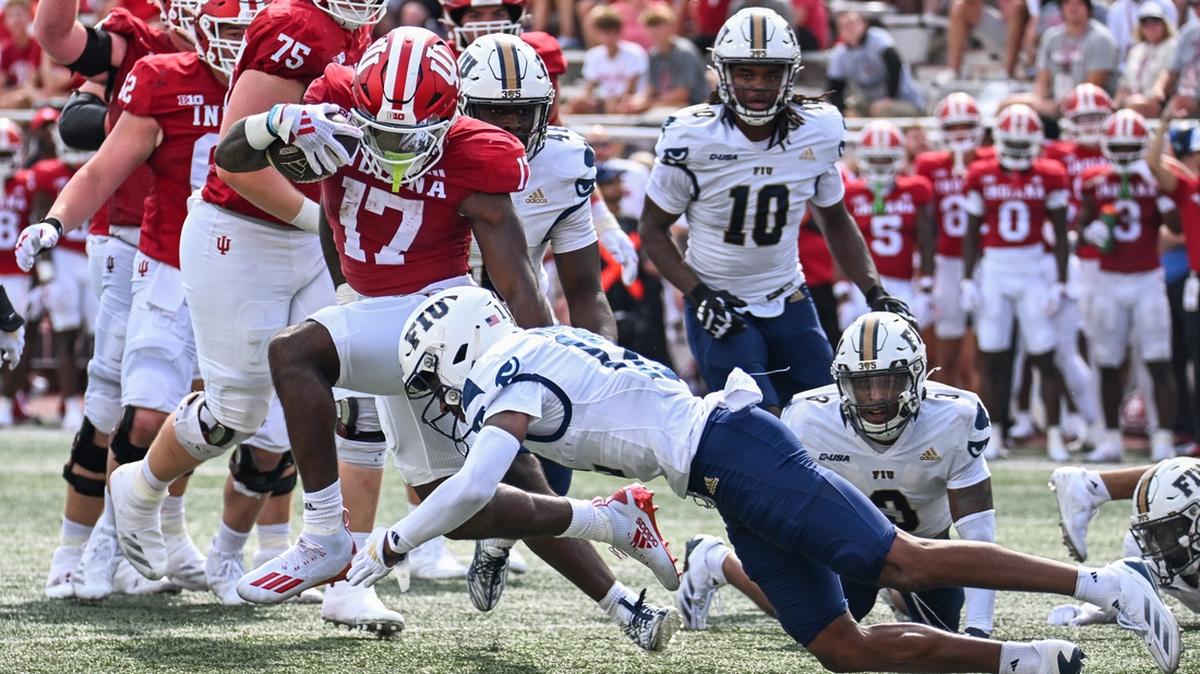 Aug 31, 2024; Bloomington, Indiana, USA; Indiana Hoosiers running back Ty Son Lawton (17) runs for a touchdown against Florida International Panthers defensive back Hezekiah Masses (12) during the first half at Memorial Stadium. Mandatory Credit: Robert Goddin-USA TODAY Sports