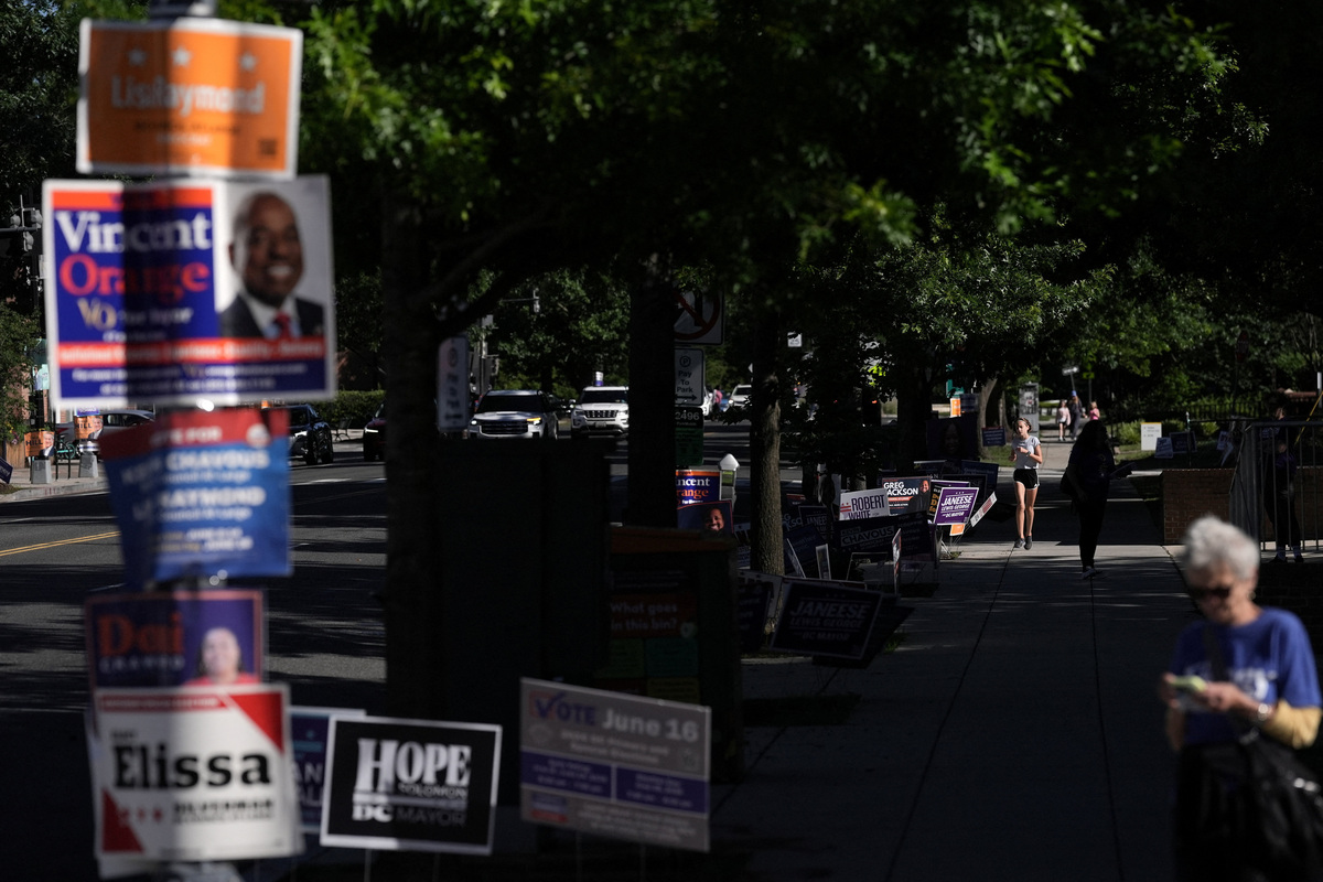 Political campaign signs line the street next to a voting site at the Chevy Chase Community Center during DC’s primary voting day in Washington, D.C., U.S., June 16, 2026. REUTERS/Leah Millis