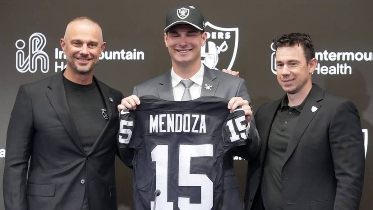  Apr 24, 2026; Henderson, NV, USA; Las Vegas Raiders quarterback Fernando Mendoza (center) poses with general manager John Spytek (left) and head coach Klint Kubiak at introductory press conference at Intermountain Health Performance Center after being selected as the No. 1 pick in the 2026 NFL Draft. Mandatory Credit: Kirby Lee-Imagn Images | Kirby Lee-Imagn Images 