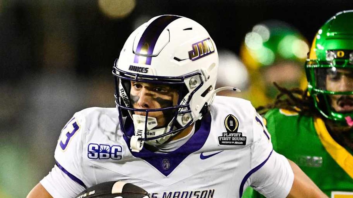  Dec 20, 2025; Eugene, OR, USA; James Madison Dukes wide receiver Landon Ellis (13) runs after making a catch as Oregon Ducks defensive back Theran Johnson (5) defends during the second quarter at Autzen Stadium. Mandatory Credit: Troy Wayrynen-Imagn Images | Troy Wayrynen-Imagn Images 