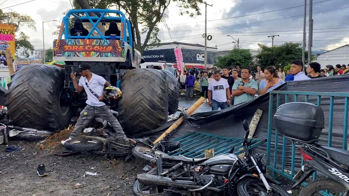 People stand near a monster truck after a driver lost control of the vehicle and plowed into spectators, killing people and injuring others, in Popayan, Cauca province, Colombia, May 3, 2026. Picture taken with a mobile phone. REUTERS/Henry Laserna