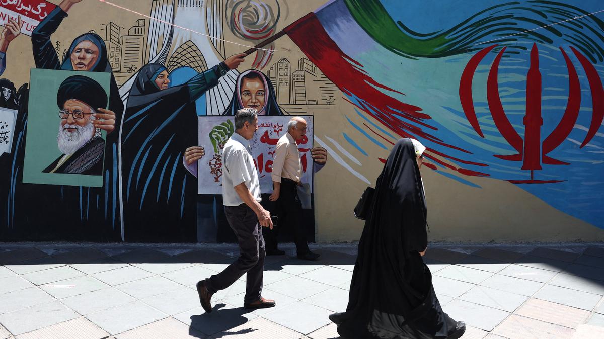 People walk on a street near a mural featuring an image of the late Supreme Leader of Iran, Ayatollah Ali Khamenei, in Tehran, Iran, June 1, 2026. Majid Asgaripour/WANA (West Asia News Agency) via REUTERS