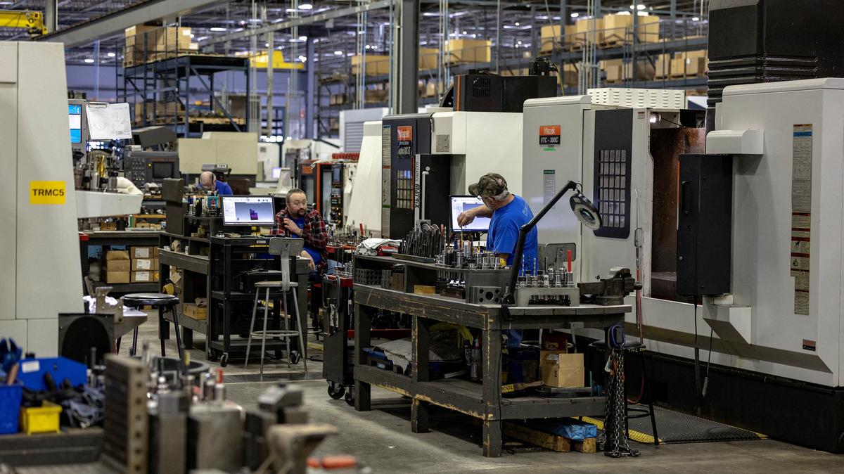 FILE PHOTO: Employees work on the production floor of the General Stamping & Metalworks building in South Bend, Indiana, U.S., March 23, 2026. REUTERS/Jim Vondruska/File Photo