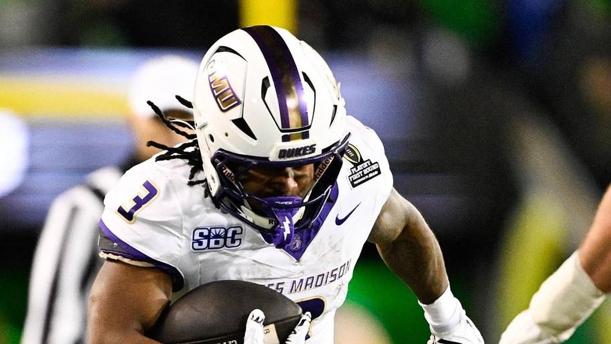  Dec 20, 2025; Eugene, OR, USA; James Madison Dukes running back Wayne Knight (3) rushes as Oregon Ducks defensive back Aaron Flowers (21) defends during the second quarter at Autzen Stadium. Mandatory Credit: Troy Wayrynen-Imagn Images | Troy Wayrynen-Imagn Images 