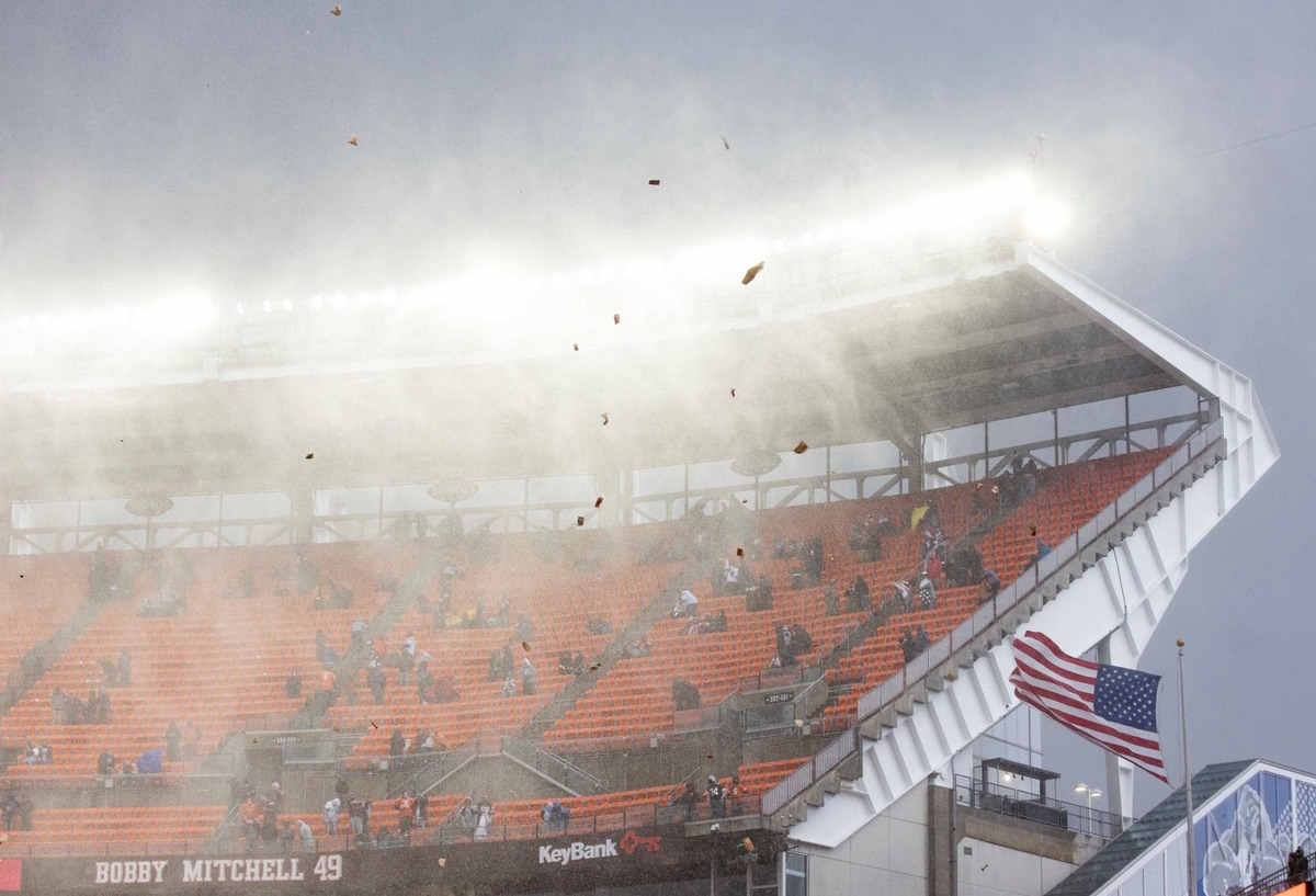  Nov 15, 2020; Cleveland, Ohio, USA; Debris flies through the air as rain and hail falls during the national anthem before the game between the Cleveland Browns and Houston Texans at FirstEnergy Stadium. The game has been delayed due to lightning. Mandatory Credit: Scott Galvin-USA TODAY Sports 