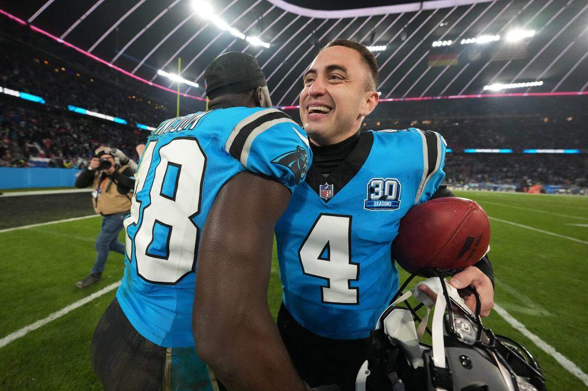 Nov 10, 2024; Munich, Germany; Carolina Panthers place kicker Eddy Pineiro (4) celebrates with linebacker Thomas Incoom (48) after kicking a 36-yard field goal in overtime against the New York Giants during the 2024 NFL Munich Game at Allianz Arena.