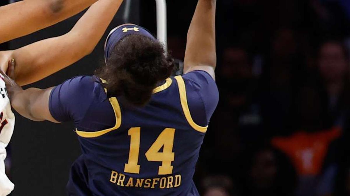  Mar 29, 2026; Fort Worth, TX, USA; Notre Dame Fighting Irish guard Kk Bransford (14) has her shot blocked by UConn Huskies forward Sarah Strong (21) during the first half at Dickies Arena. Mandatory Credit: Chris Jones-Imagn Images | Chris Jones-Imagn Images 