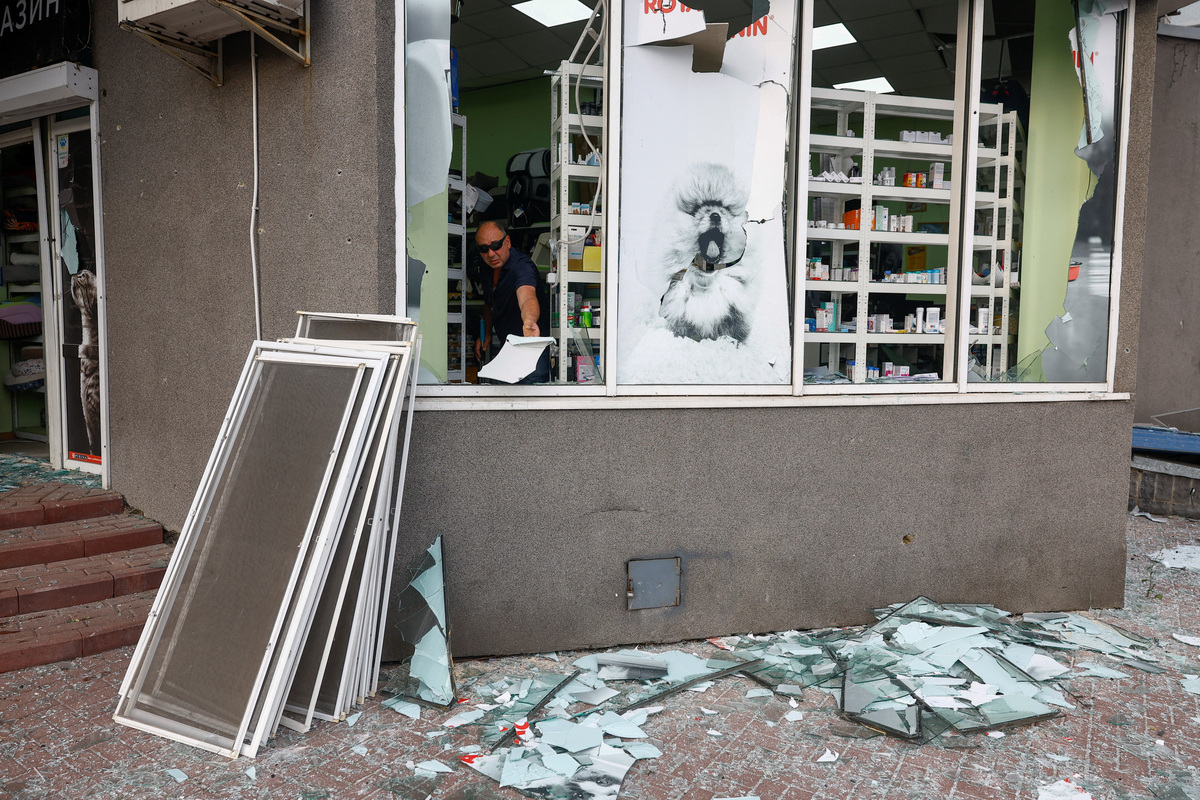 A resident removes debris from his pet shop, which was damaged during Russian missile strikes, amid Russia's attack on Ukraine, in Kyiv, Ukraine July 11, 2026. REUTERS/Valentyn Ogirenko