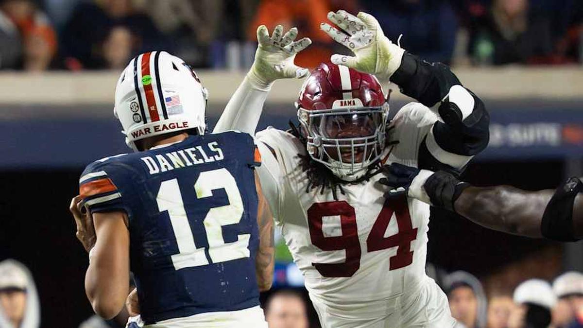  Nov 29, 2025; Auburn, Alabama, USA; Alabama defensive lineman Edric Hill (94) pressures Auburn quarterback Ashton Daniels (12) at Jordan-Hare Stadium. Alabama defeated Auburn 27-20. Mandatory Credit: Gary Cosby Jr.-Tuscaloosa News | Gary Cosby Jr.-Tuscaloosa News / USA TODAY NETWORK via Imagn Images 