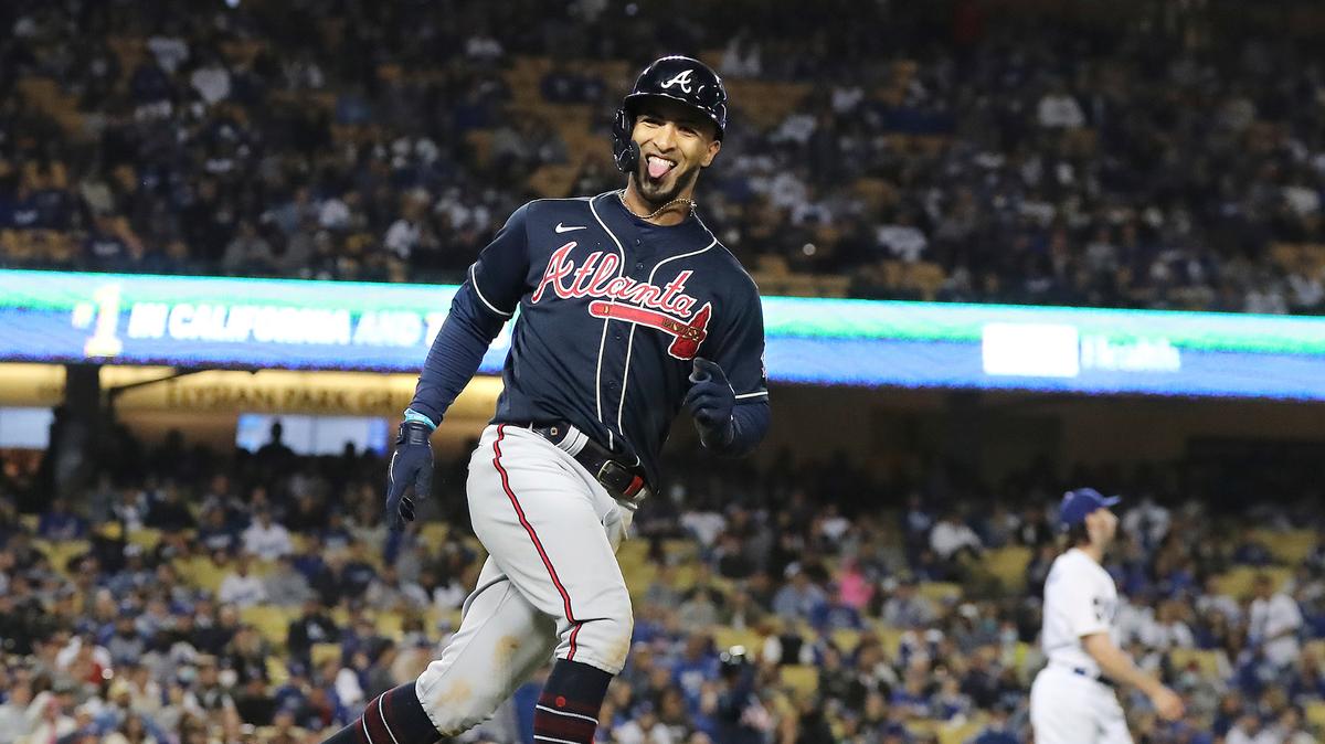 Atlanta Braves’ Eddie Rosario reacts to his three-run home run in the ninth inning off Los Angeles Dodgers pitcher Tony Gonsolin, right, during Game 4 of the baseball NL Championship Series, Wednesday, Oct. 20, 2021, in Los Angeles. (Curtis Compton/Atlanta Journal-Constitution via AP)