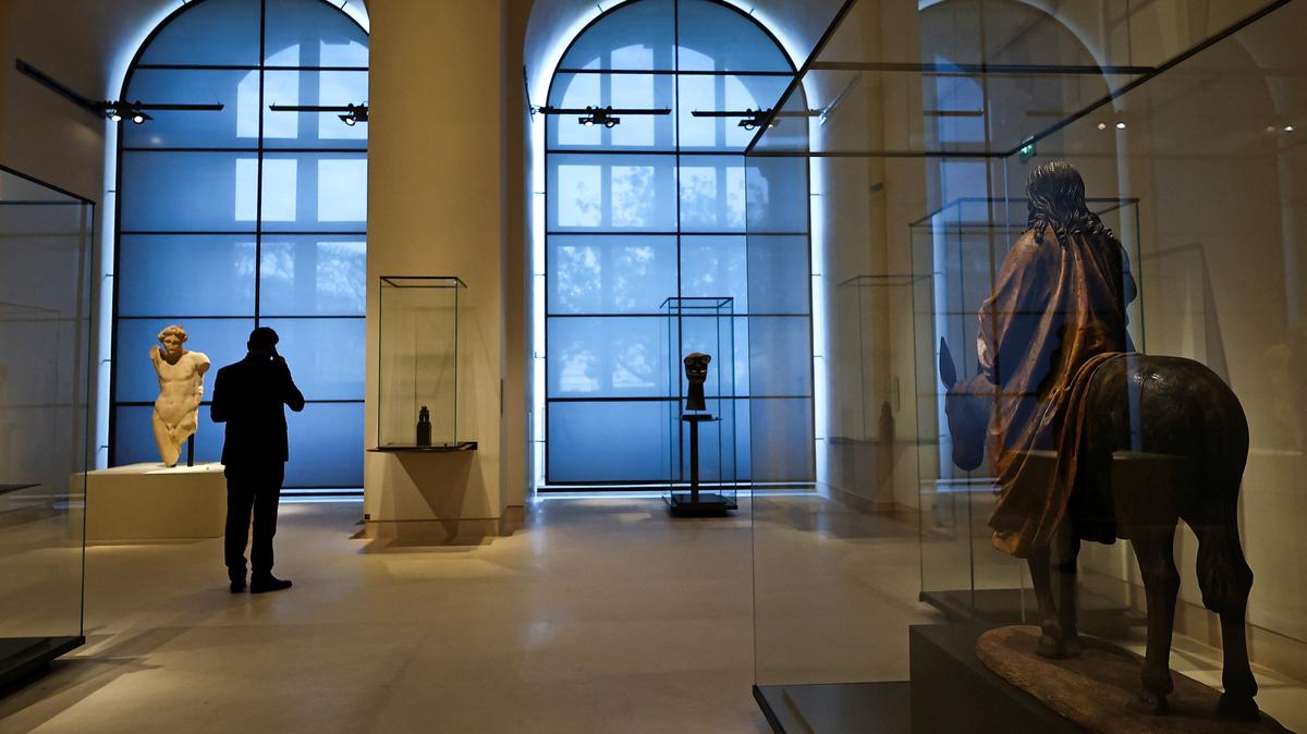 A man talks on the phone at the renovated Gallery of Five Continents (Galerie des Cinq Continents) in the Denon wing (Aile Denon) during a press preview at the Louvre Museum in Paris, France, December 2, 2025. REUTERS/Gonzalo Fuentes