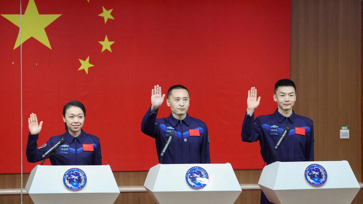 Astronauts Zhu Yangzhu, Zhang Zhiyuan, and Lai Ka-ying, who is the first astronaut from Hong Kong, gesture as they attend a press conference before the Shenzhou-23 spaceflight mission to China's Tiangong space station, at Jiuquan Satellite Launch Center, near Jiuquan, Gansu province, China, May 23, 2026. REUTERS/Maxim Shemetov