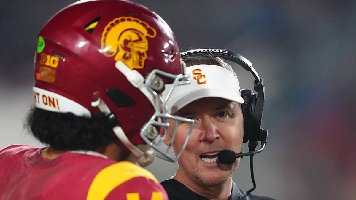  Nov 29, 2025; Los Angeles, California, USA; Southern California Trojans head coach Lincoln Riley (right) talks with quarterback Jayden Maiava (14) in the second half against the UCLA Bruins at United Airlines Field at Los Angeles Memorial Coliseum. Mandatory Credit: Kirby Lee-Imagn Images | Kirby Lee-Imagn Images 