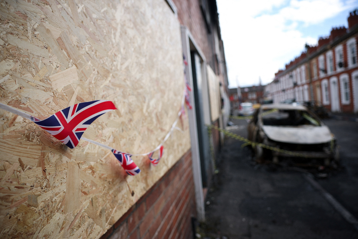 A Union Jack banting hangs on a boarded up house, in the aftermath of anti-immigrant protests following a knife attack on June 8, which left a man seriously injured and prompted police to declare a critical incident, at Lendrick street, east Belfast, Northern Ireland, June 10, 2026. REUTERS/Isabel Infantes