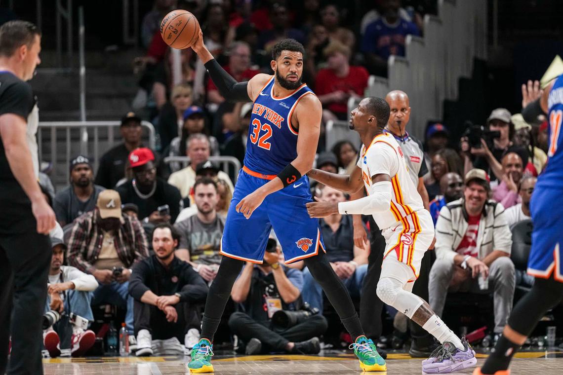  New York Knicks center Karl-Anthony Towns (32) holds the ball away from Atlanta Hawks forward Jonathan Kuminga (0). 