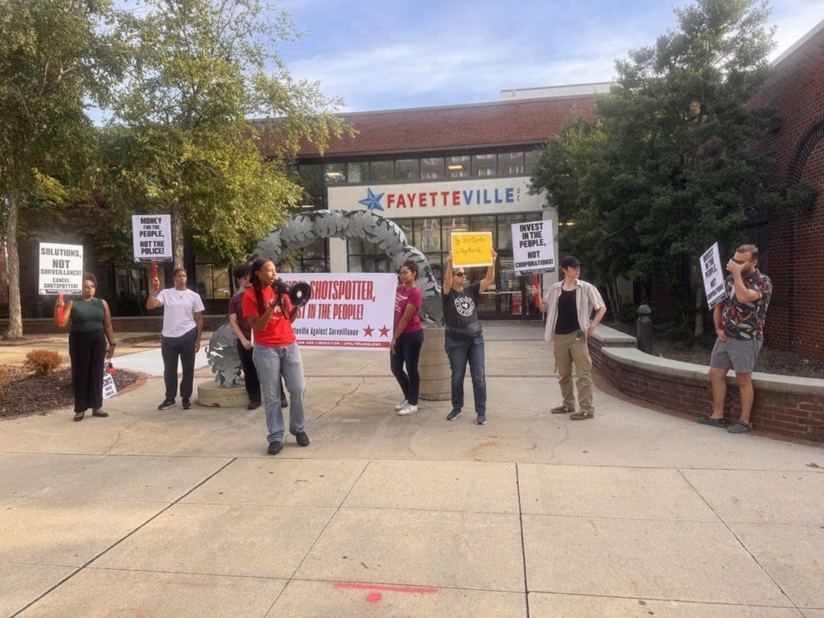 Party for Socialism & Liberation member, Kristen Starks, pictured with the megaphone, leading ShotSpotter protestors in chants outside Fayetteville City Hall on Hay Street, Wednesday, Aug. 13, 2025.