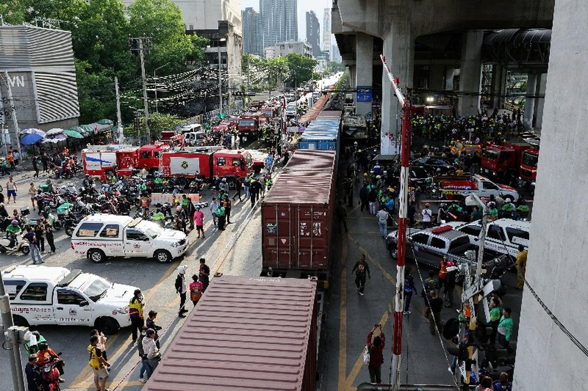 Emergency services work at a site where a train collided with a bus, several cars and motorcycles on Asok-Din Daeng Road, causing several casualties, in Bangkok, Thailand, May 16, 2026. REUTERS/Athit Perawongmetha