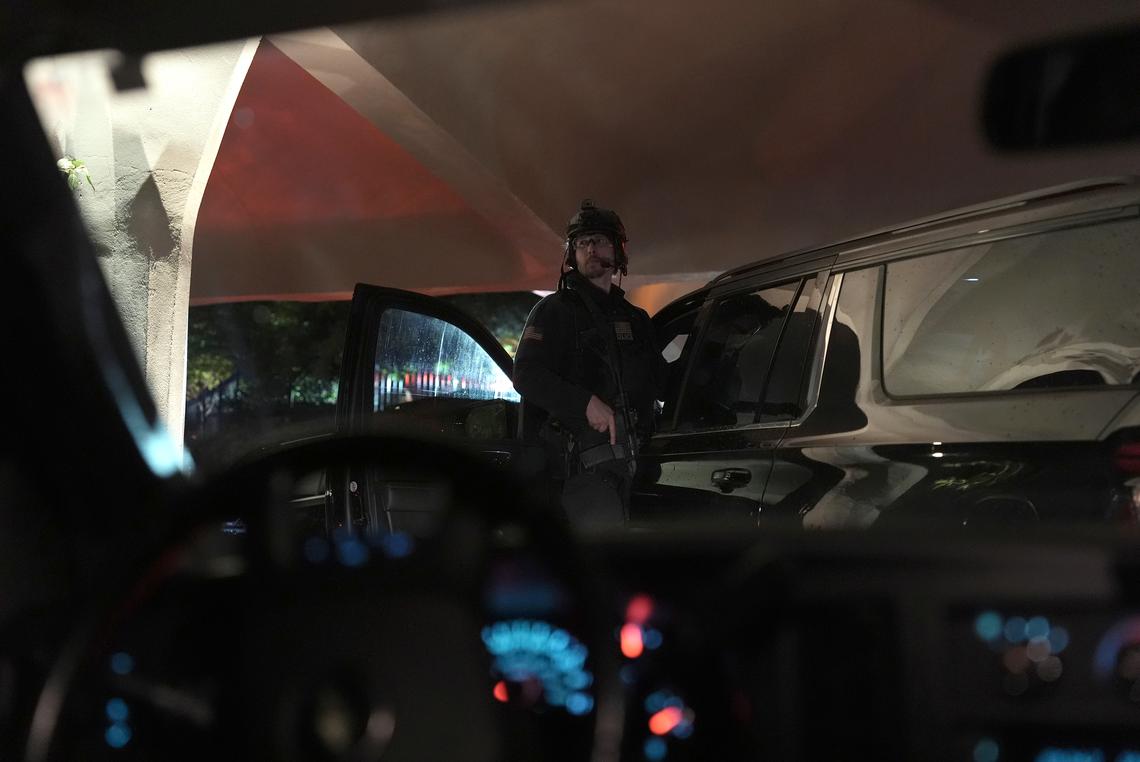 An armed member of the Secret Service Counter Assault Team looks out from a vehicle in President Donald Trump's motorcade outside the Washington Hilton after shots were fired at the White House Correspondents' Association dinner in Washington on Saturday, April 25, 2026. President Donald Trump was rushed from the stage but appeared to be unharmed. (Salwan Georges/The New York Times)