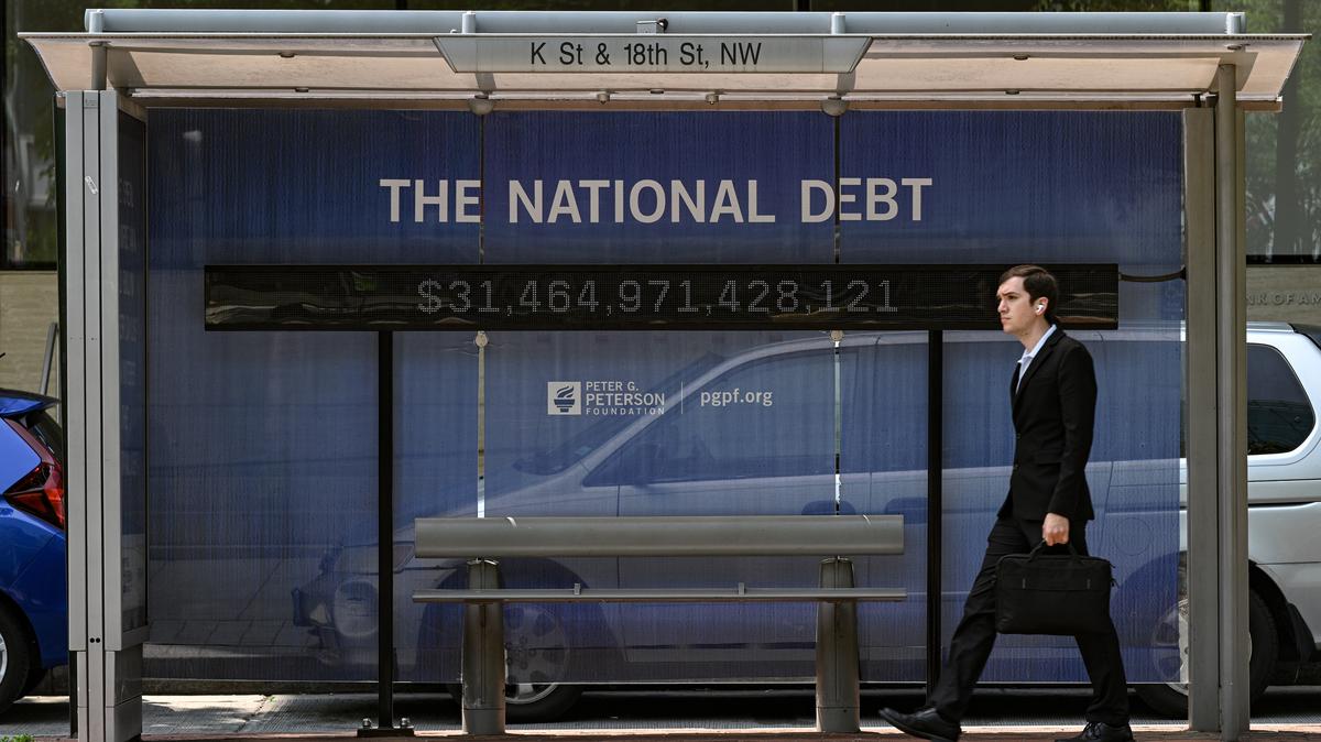A national debt ticker at a bus stop in Washington on May 22, 2023. The current value is trillions of dollars higher now, and the ratio of U.S. government debt to GDP -- a widely regarded metric for assessing the government’s fiscal health -- slightly exceeds 100%.