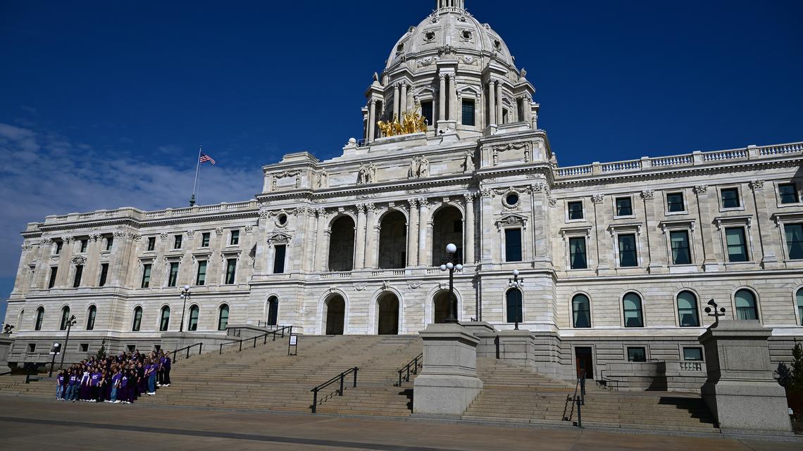 A group of visitors pose for a photo on the steps of the state Capitol building in St. Paul, Minnesota, on March 25, 2026. (John Autey/St. Paul Pioneer Press/TNS)