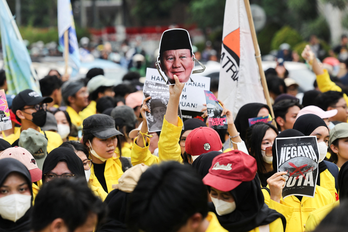 A student holds up a face mask depicting Indonesian President Prabowo Subianto during a protest against government policies, including state budget spending, fuel price hike, free meals programme, and expanded military roles in civilian affairs, in Jakarta, Indonesia, June 12, 2026. REUTERS/Ajeng Dinar Ulfiana