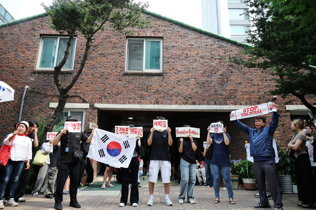 Far-right protesters chant slogans, calling for a halt to vote counting and a rerun of the race, as they surround a polling station where ballot boxes for local elections are still kept in, in Seoul, South Korea, June 4, 2026.     REUTERS/Kim Hong-Ji