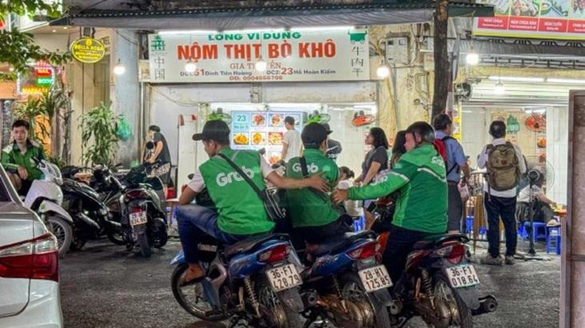 Grab drivers wait for ride requests in Hanoi, Vietnam. Photo by Asia Today