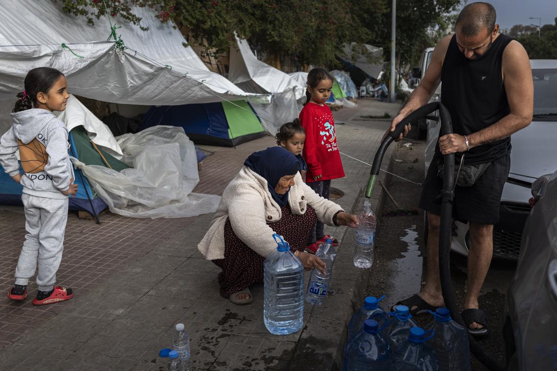Bottles are filled with water on a street in Beirut, April 18, 2026. Prime Minister Benjamin Netanyahu said Israeli troops would remain inside Lebanon, as part of what he called an "expanded security zone" from Lebanon's Mediterranean coast to its border with Syria, south of the Litani River. (Diego Ibarra Sánchez/The New York Times)