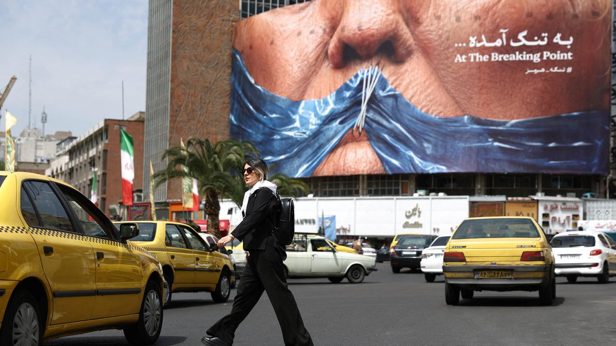 A woman walks past an anti-U.S. billboard depicting U.S. President Donald Trump and the Strait of Hormuz, in Tehran, Iran, May 2, 2026. Majid Asgaripour/WANA (West Asia News Agency) via REUTERS