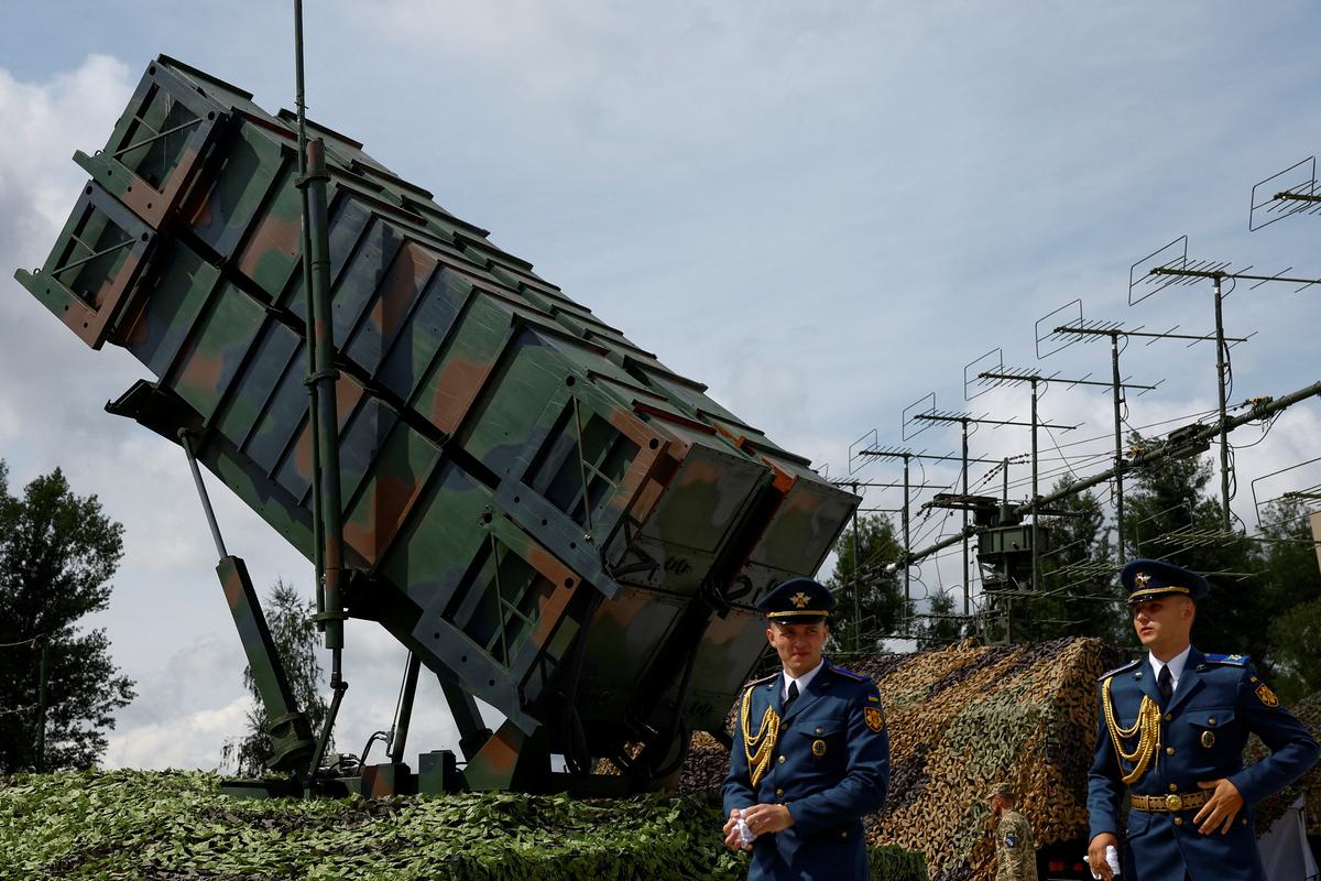 FILE PHOTO: Members of the Honour Guard walk next to a launcher of a Patriot air defence system after marking the Day of the Ukrainian Air Forces, amid Russia's attack on Ukraine, in an undisclosed location, Ukraine August 4, 2024. REUTERS/Valentyn Ogirenko/File Photo