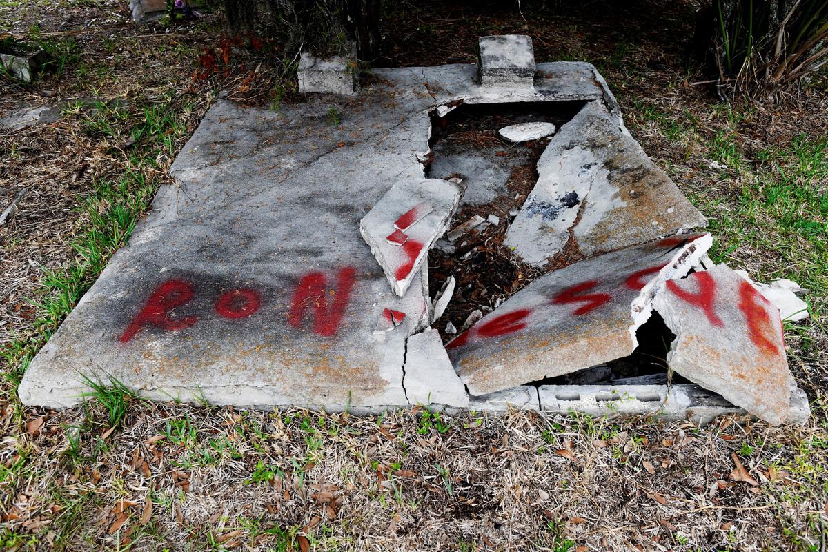 A broken and spray-painted grave at The Old Memphis Cemetery, a predominantly African-American cemetery, after the place was vandalized, with 17 gravesites and several headstones damaged in Palmetto, Florida, U.S., May 14, 2026. Authorities say “Trump” and “DeSantis” were spray-painted in red across several tombs as police continue investigating the incident. REUTERS/Octavio Jones