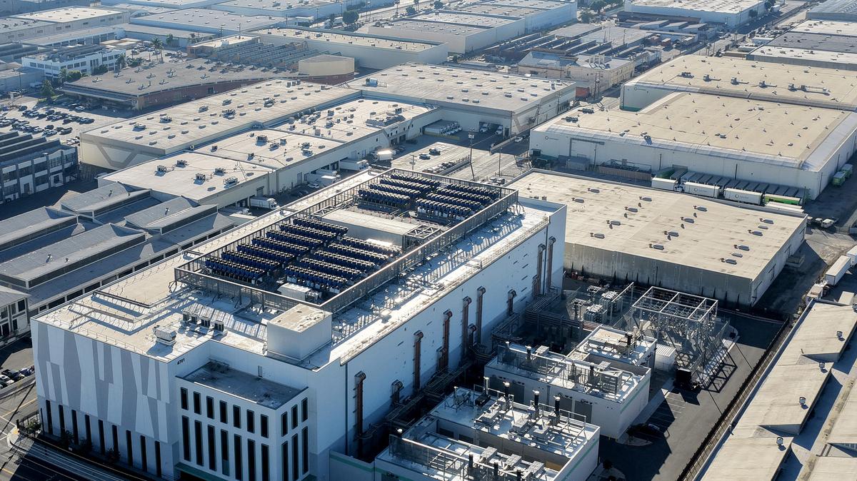An aerial view of a 33 megawatt data center (LOWER L) with closed-loop cooling system, amid warehouses on Oct. 20, 2025, in Vernon, California. A surge in demand for AI infrastructure is fueling a boom in data centers across the country and around the globe. (Mario Tama/Getty Images/TNS)