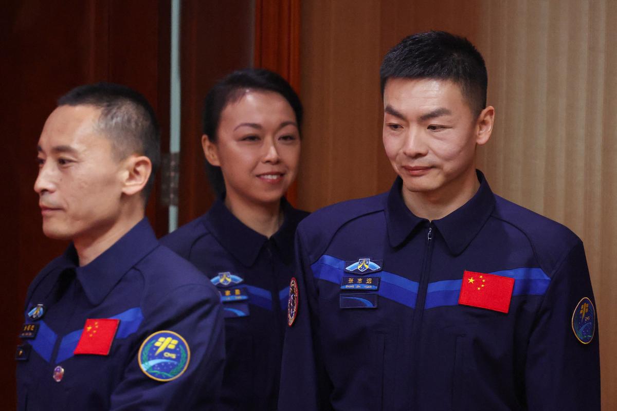 Astronauts Zhu Yangzhu, Zhang Zhiyuan, and Lai Ka-ying, who is the first astronaut from Hong Kong, walk to attend a press conference before the Shenzhou-23 spaceflight mission to China's Tiangong space station, at Jiuquan Satellite Launch Center, near Jiuquan, Gansu province, China, May 23, 2026. REUTERS/Maxim Shemetov