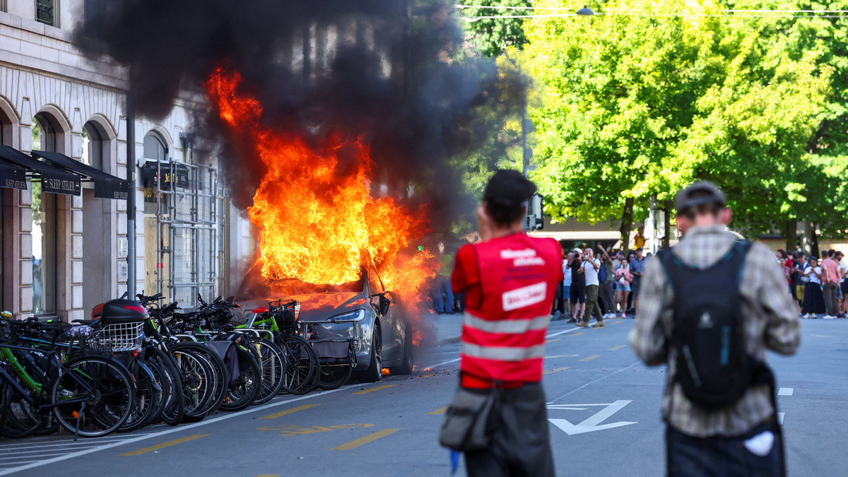 A Tesla car burns in Geneva during a protest against the upcoming G7 summit in Evian-les-Bains, France, on Sunday.