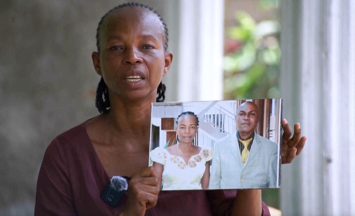Justine Tangakeya Basekauke, widow of murdered health worker Dr. John Tangakeya, holds a photo of the two of them together during an interview with Reuters in Kisangani, Democratic Republic of Congo, April 16, 2026, in this still image obtained from a video. REUTERS/Reuters TV