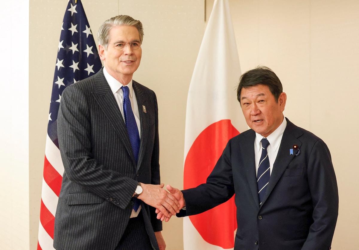 U.S. Treasury Secretary Scott Bessent shakes hands with Japan's Foreign Minister Toshimitsu Motegi at the start of their talks at the Foreign Ministry in Tokyo, Japan May 12, 2026. REUTERS/Issei Kato