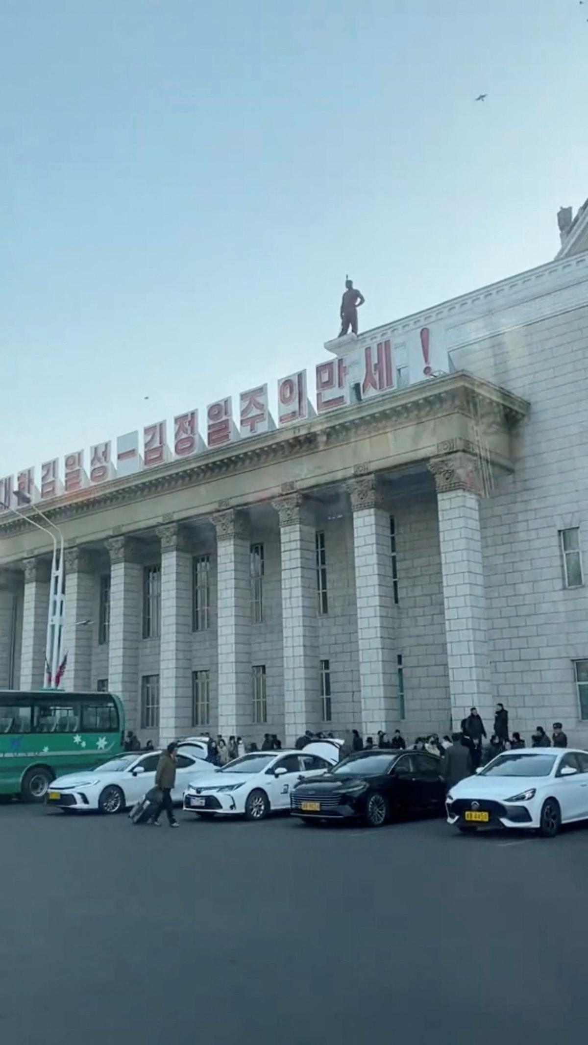 Cars with yellow license plates are parked outside the Pyongyang train station in Pyongyang, North Korea, in this screengrab obtained from a social media video released March 13, 2026. SOCIAL MEDIA/via REUTERS