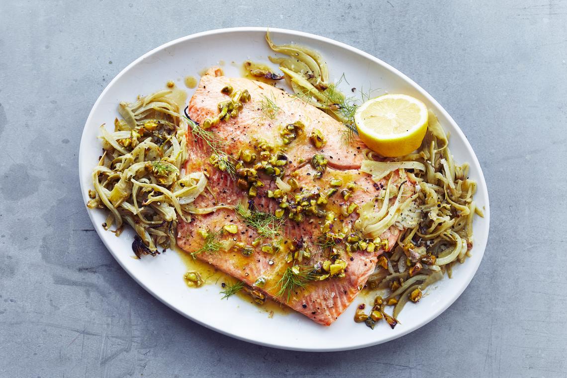 Wild salmon with fennel and pistachios. Because of their active lives and varied diet, wild salmon can be more nuanced and robust than farmed fish. Food styled by Simon Andrews. (Con Poulos/The New York Times)
