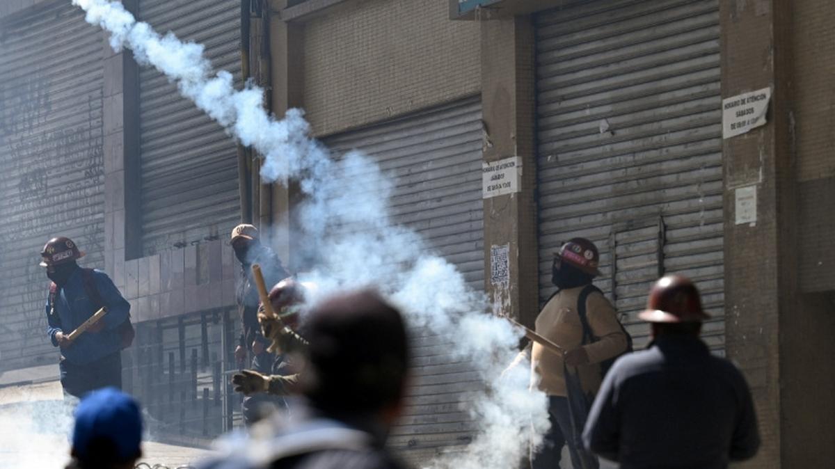A demonstrator throws a smoking projectile during a march calling for the resignation of Bolivia's President Rodrigo Paz, as the country's economic and fuel crisis worsens due to a shortage of U.S. dollars and falling domestic energy production, in La Paz, Bolivia May 18, 2026. REUTERS/Claudia Morales