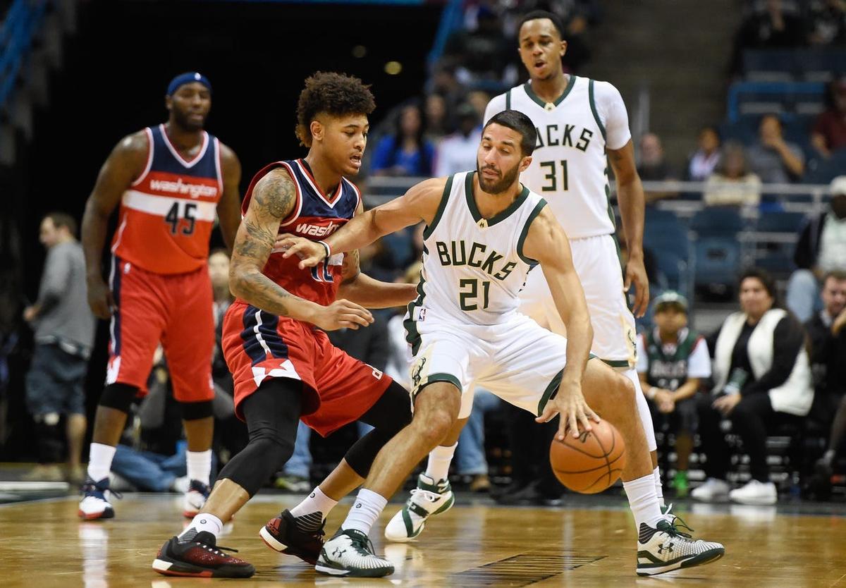 Oct 17, 2015; Milwaukee, WI, USA; Washington Wizards forward Kelly Oubre Jr. (12) guards Milwaukee Bucks guard Greivis Vasquez (21) in the second quarter at BMO Harris Bradley Center. Mandatory Credit: Benny Sieu-USA TODAY Sports