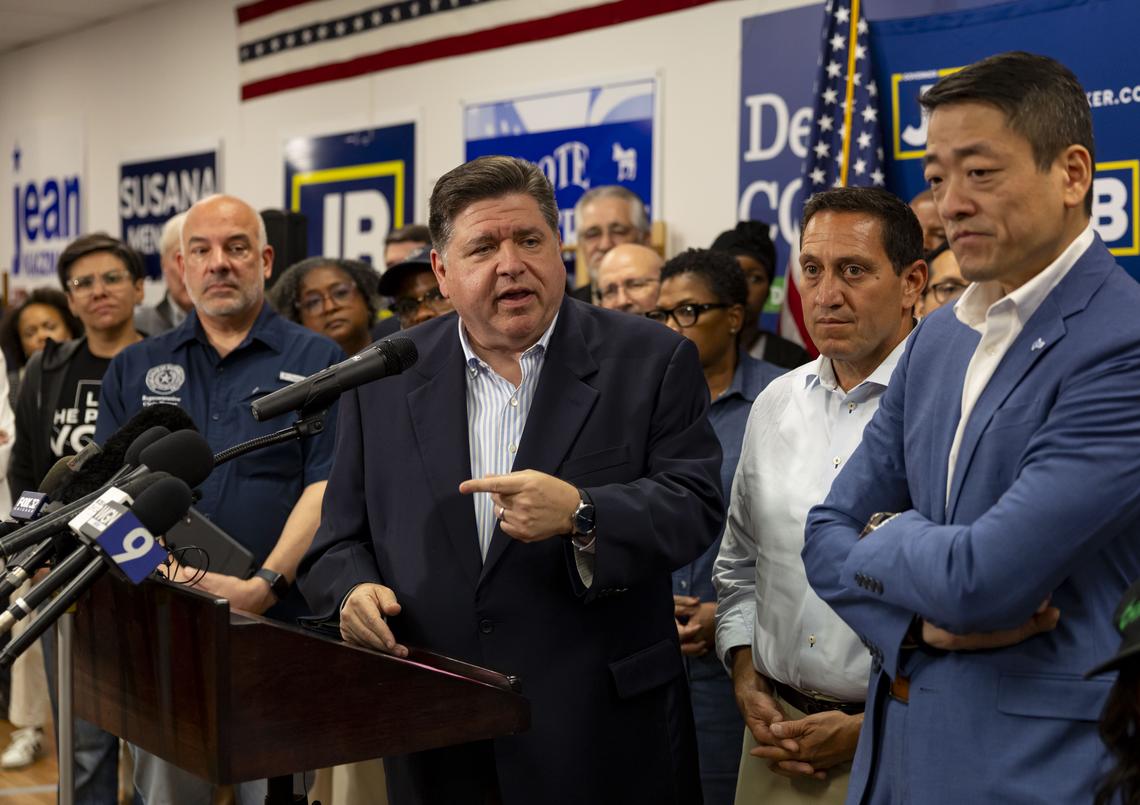 Illinoi Gov. JB Pritzker speaks alongside Gene Wu, right, the Texas House Democratic Caucus chair, and other Texas Democrats on Aug. 3, 2025, after their arrival at the DuPage County Democratic Party headquarters in Carol Stream, Illinois. (Brian Cassella/Chicago Tribune)